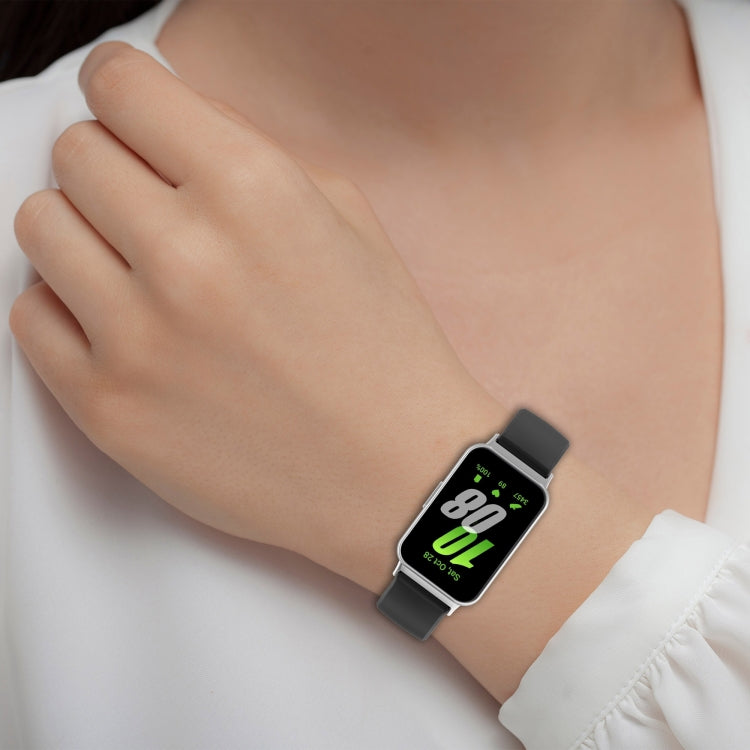 Liquid glossy silicone watch band with metal connector, worn on wrist with black strap