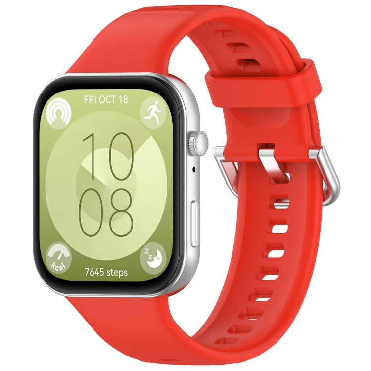 Red silicone sports watch band with silver buckle, shown fitted to a watch