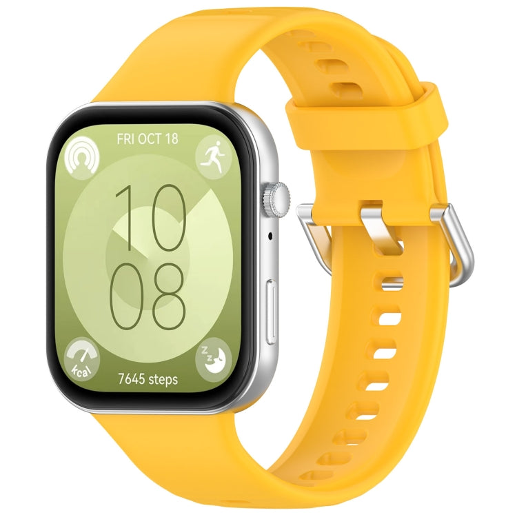 Yellow silicone sports watch band with silver buckle, shown fitted to a watch