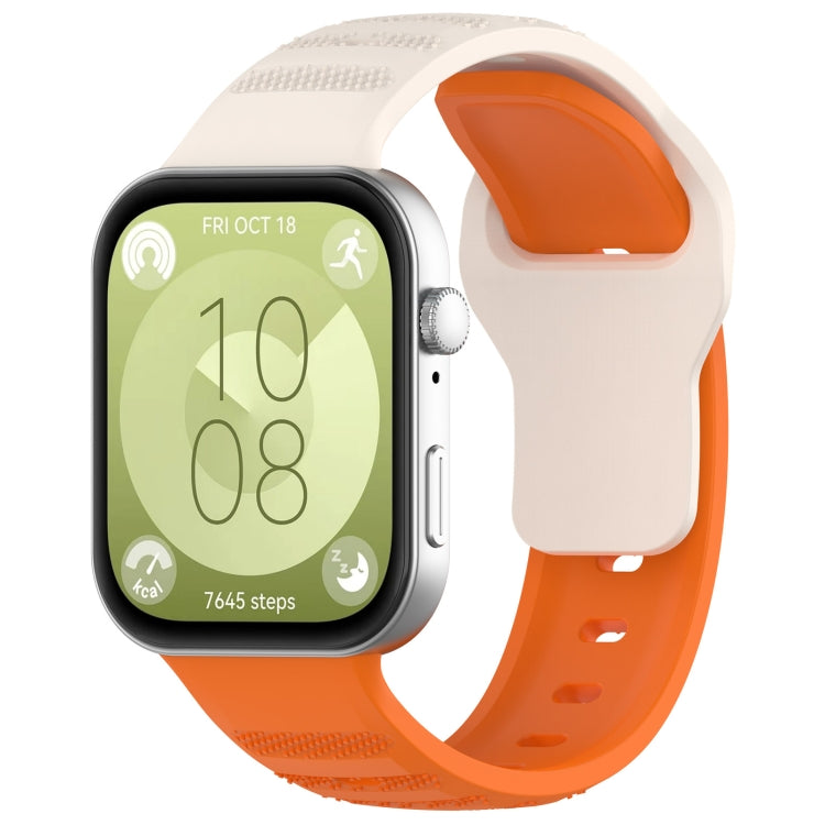 White and orange silicone sports watch band with textured grip sections, shown on a smartwatch.