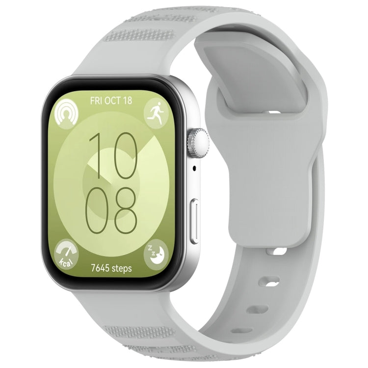 Light gray silicone sports watch band with textured grip sections, shown attached to a smartwatch.
