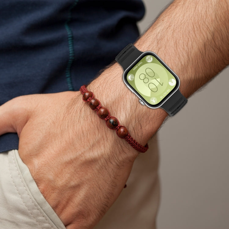 Black silicone sports watch band worn on a wrist, shown on a smartwatch.
