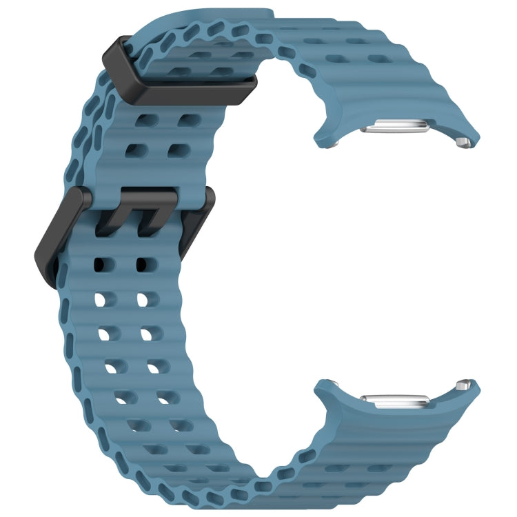Reverse side of blue silicone watch band with ventilated holes and metal connectors