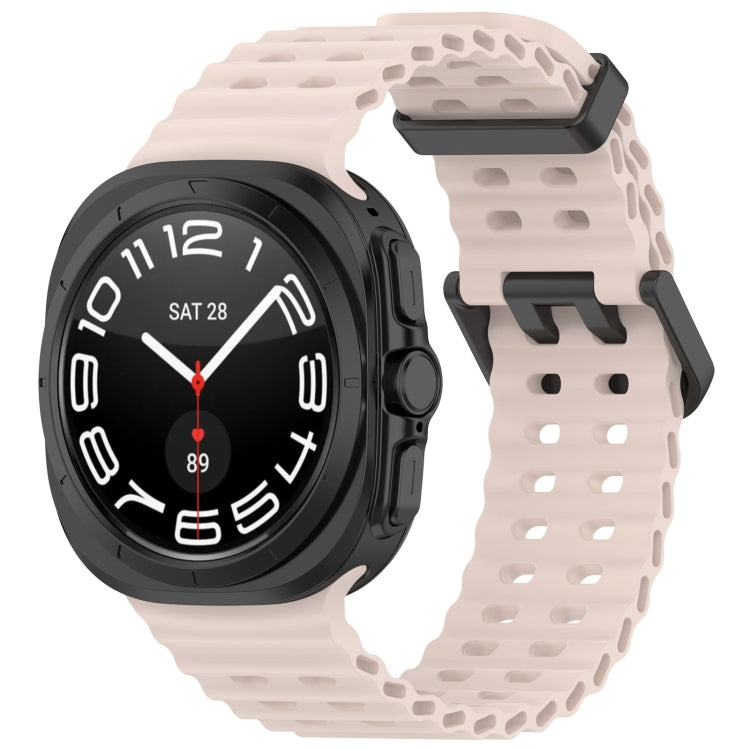 Pale pink silicone watch band with ventilated holes and dual buckle, shown on a smartwatch