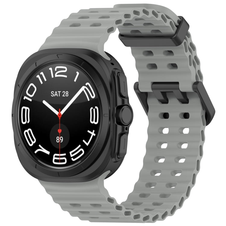 Gray perforated silicone watch band with dual buckle, shown on a black smartwatch
