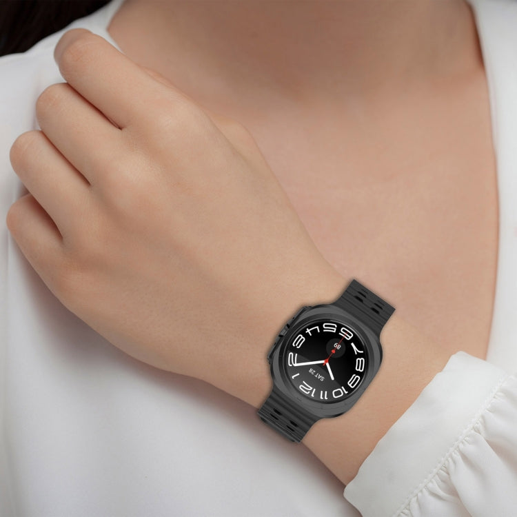 Black perforated silicone watch band worn on a wrist