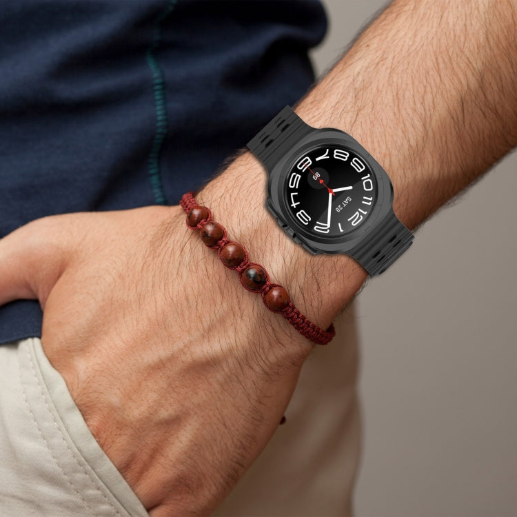 Black perforated silicone watch band worn on a wrist
