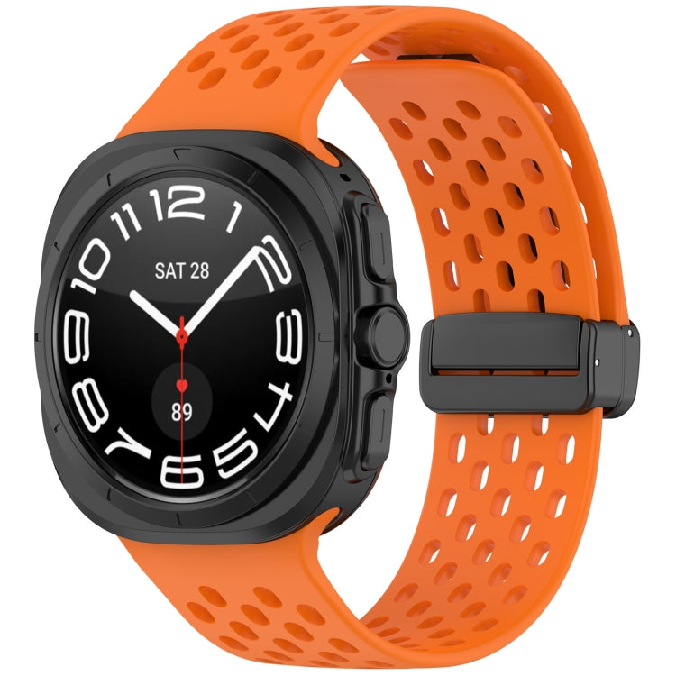 Orange perforated silicone watch band with magnetic folding buckle, shown on a smartwatch