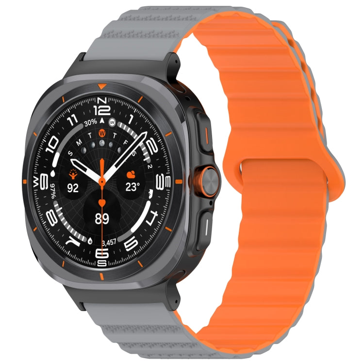 Galaxy Watch Ultra silicone band with an orange ridged strap and gray spotted ends