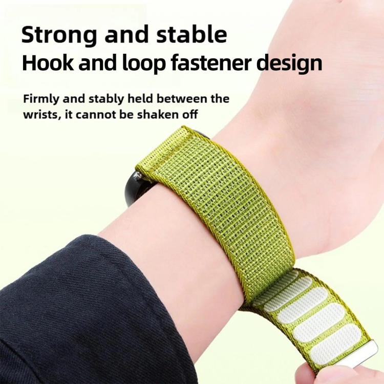 Lime green woven nylon watch band worn on a wrist, with hook-and-loop fastening