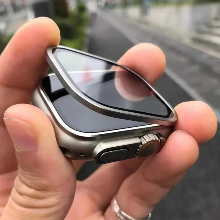 Silver metal-frame tempered glass watch screen protector held above a watch face