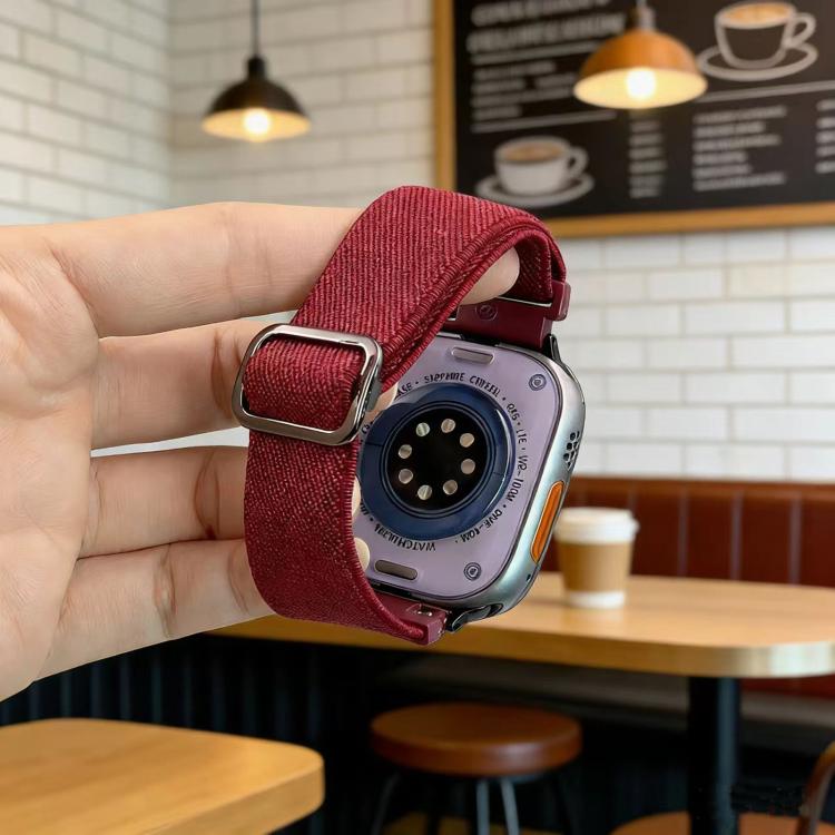 Wine red nylon elastic watch band with a metal D-ring buckle, shown on a smartwatch