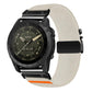 Light cream stretch nylon watch band with diagonal weave, black buckle, and orange accent