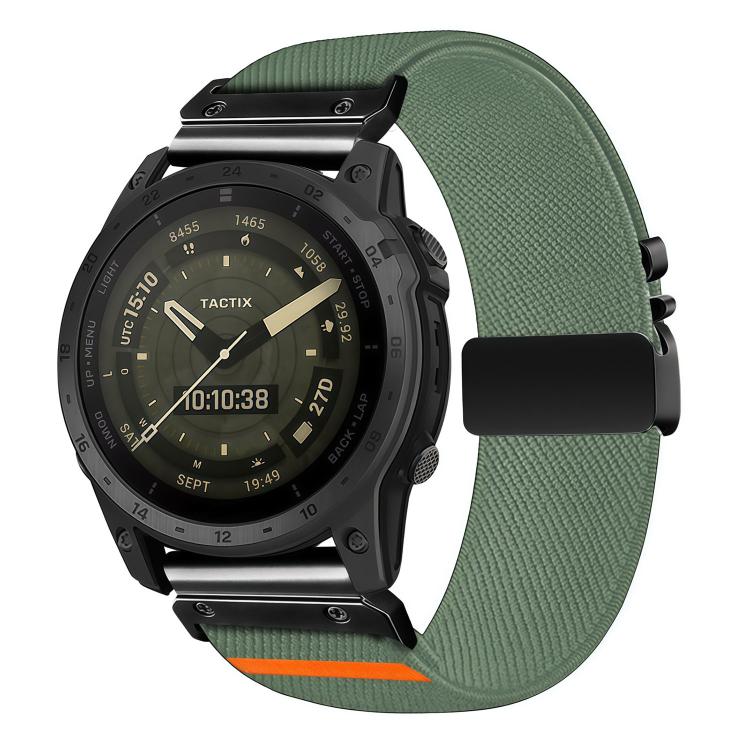 Green diagonal-weave stretch nylon watch band with black buckle and orange accent, shown on a watch