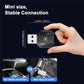 Black M36 wireless adapter with size shown, pinched by a hand
