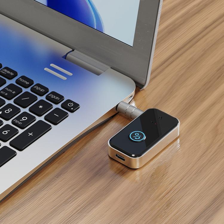 Bluetooth audio transmitter/receiver adapter on desk, black module with blue power ring
