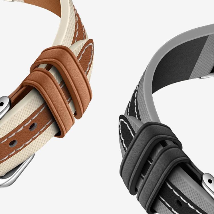 Leather watch bands in tan and dark gray with contrast stitching and buckle loops