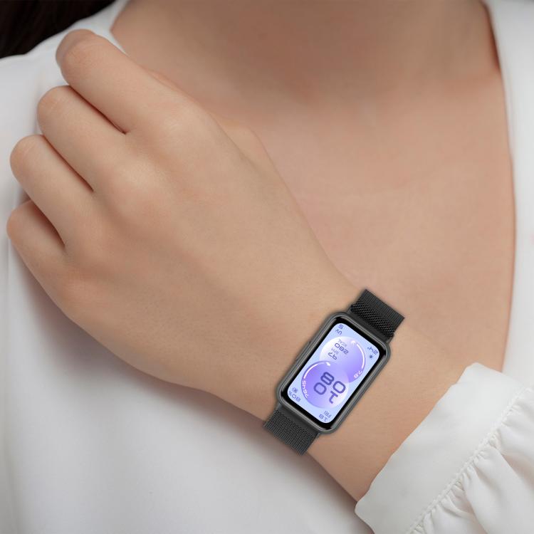 Black Milanese metal watch band worn on a wrist with a rectangular smartwatch.