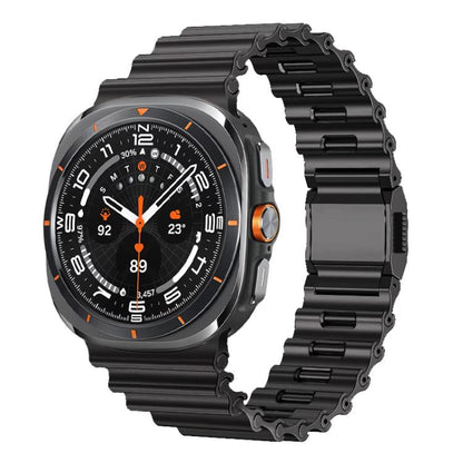 Black stainless steel watch band with wave-textured links and folding clasp, shown on a smartwatch