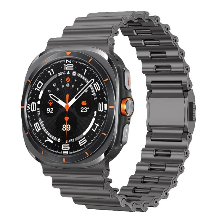 Black stainless steel watch band with wave-textured links and folding clasp, shown on a smartwatch