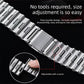 Silver stainless steel watch band with press-to-adjust links and a folding clasp