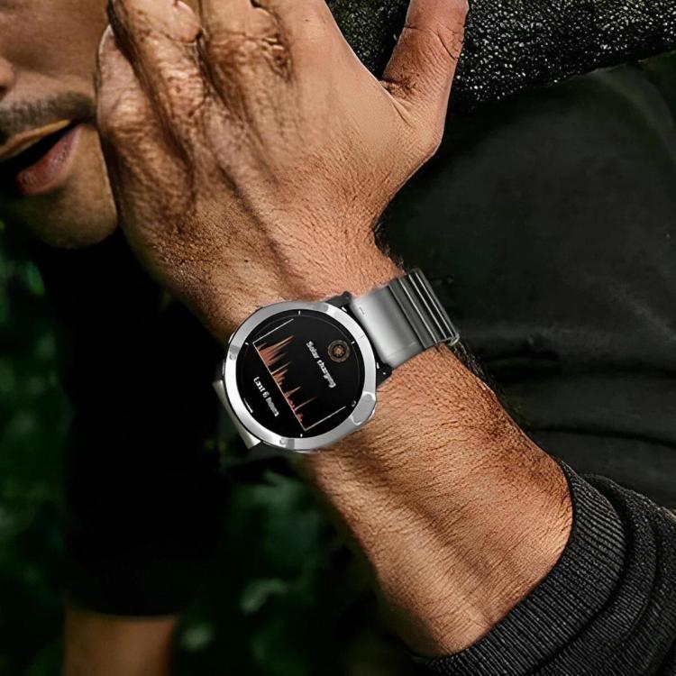 Silver metal link watch band worn on the wrist with a Garmin watch
