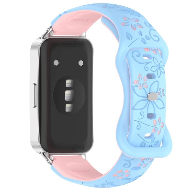 Light blue and pink floral cutout watch band with reverse buckle, attached to a smartwatch
