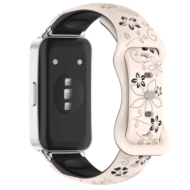 Cream and black floral cutout watch band with reverse buckle, attached to a smartwatch
