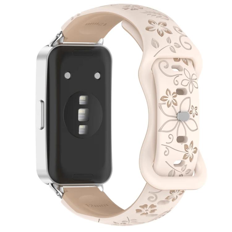 Two-tone watch band with pale pink floral engraving and reverse buckle, shown on a watch