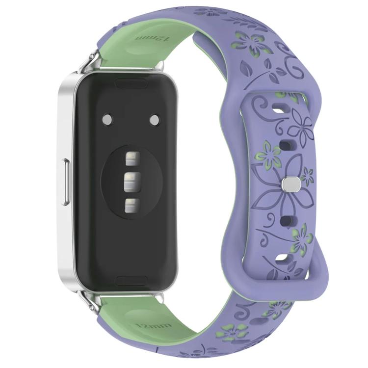 Purple and green floral watch band with a reverse buckle, shown on a watch