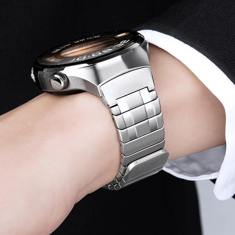 Silver stainless steel watch band fastened around a wrist