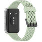 Light green perforated silicone watch band with dual buckle, shown attached to watch