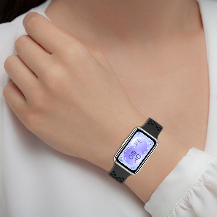 Black perforated silicone watch band worn on a wrist.