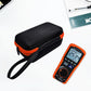 Hard storage case with orange zipper, showing a multimeter and test leads inside