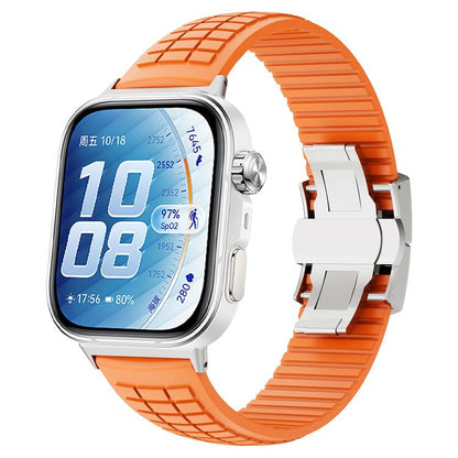 Orange silicone watch band with knurled texture and folding buckle, shown on a smartwatch