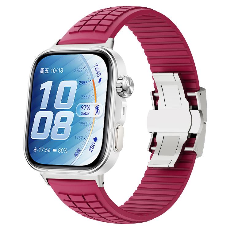 Wine red silicone watch band with knurled texture and folding buckle on a smartwatch