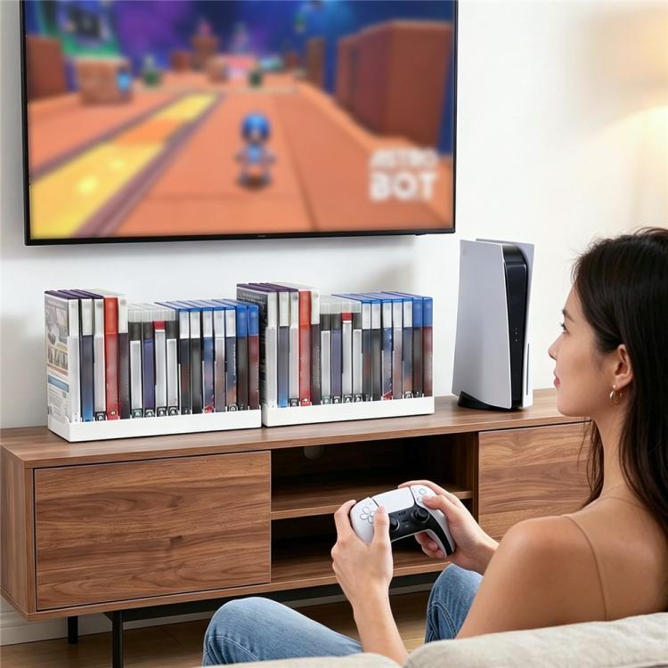 Universal disc holder on a TV stand with game cases beside a controller