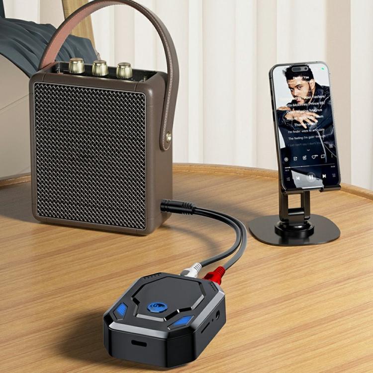 Bluetooth audio transceiver adapter on desk with connected cables for speaker and phone