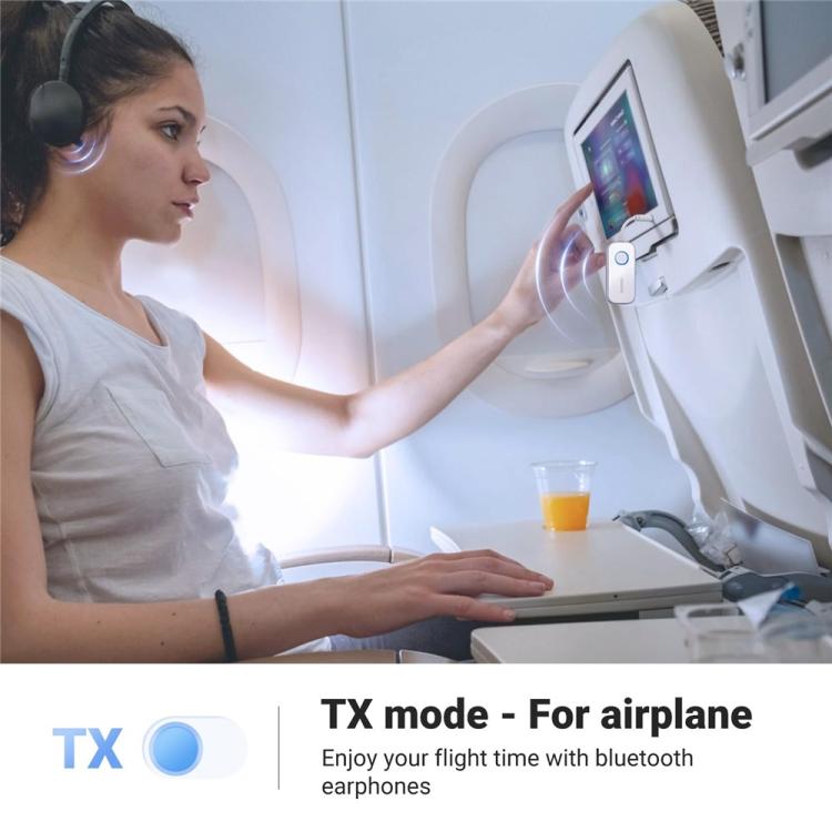 Compact 3.5mm Bluetooth audio adapter mounted on an airplane seatback
