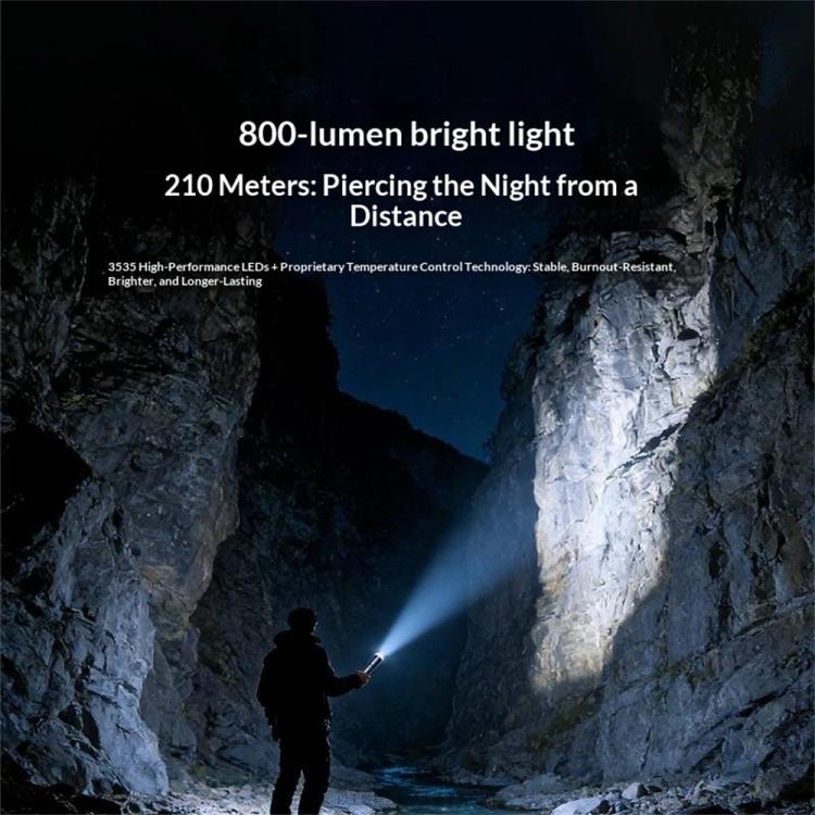 Silver-gray flashlight projecting a bright beam from the front lens