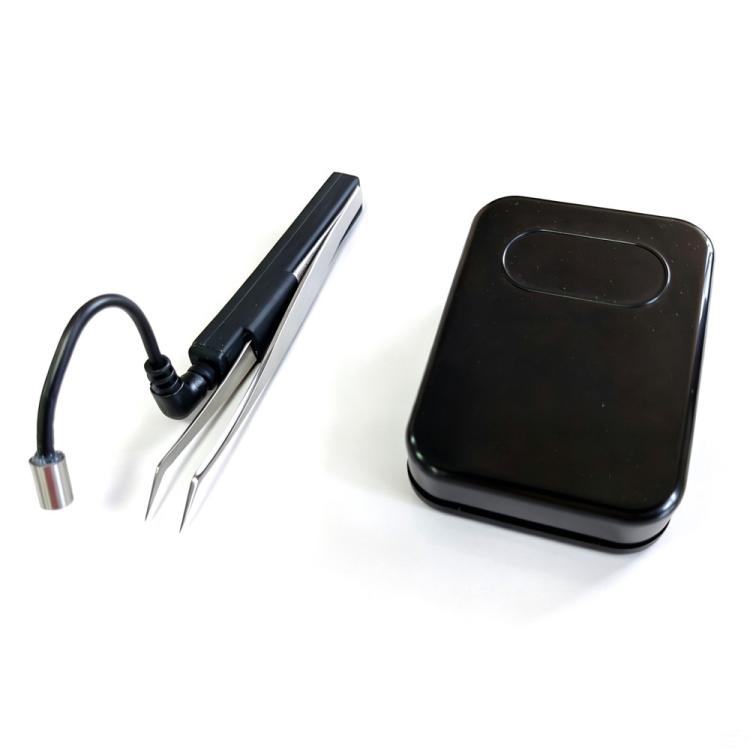 Black wireless foot pedal with attached cable and UV eyelash curing lamp