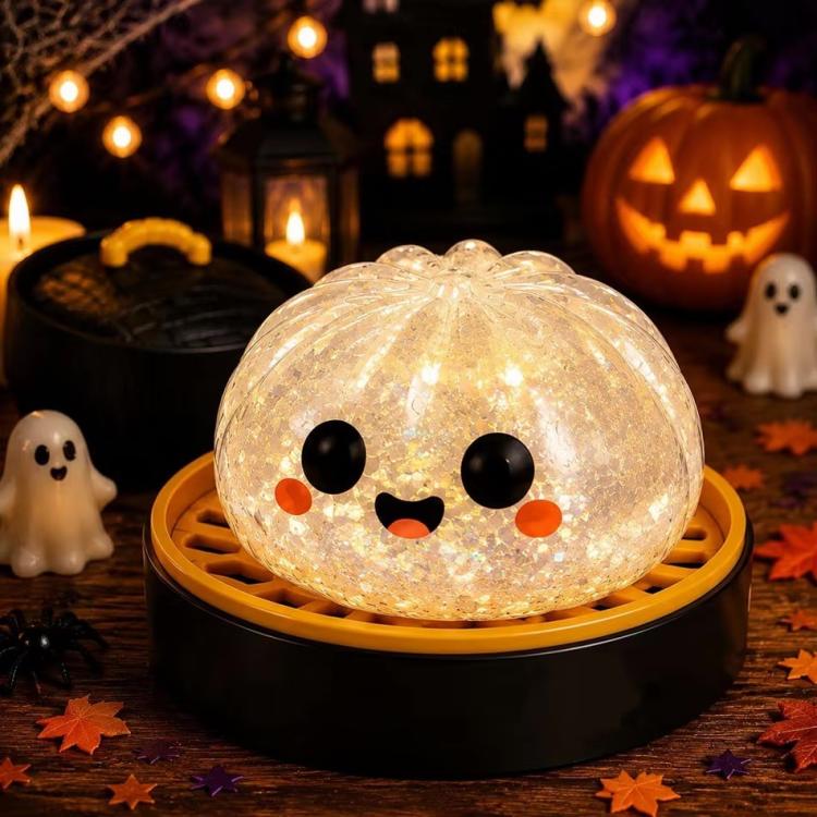 White ghost-face dumpling squishy stress relief toy with orange cheeks and smile