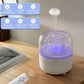 White aroma diffuser with purple-lit rotating jellyfish effect, front control panel