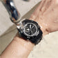 Men's waterproof sports watch on wrist, black dial with water-splash droplets
