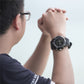 Men's black waterproof sports watch on wrist, side view showing buttons and bezel