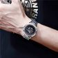 Men's steel-bracelet watch on wrist with black racing-wheel dial and red accents.