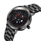 Men's analog watch close-up, black dial with red accents and steel link bracelet