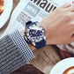 Men’s quartz sports watch on wrist, blue dial and blue silicone band close-up