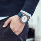 Men's quartz chronograph watch on wrist, blue leather strap and silver case