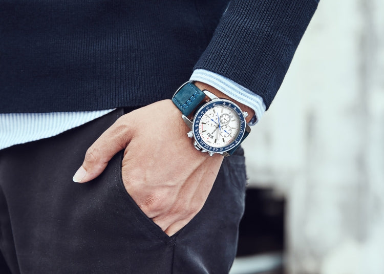 Men's quartz chronograph watch on wrist, blue leather strap and silver case